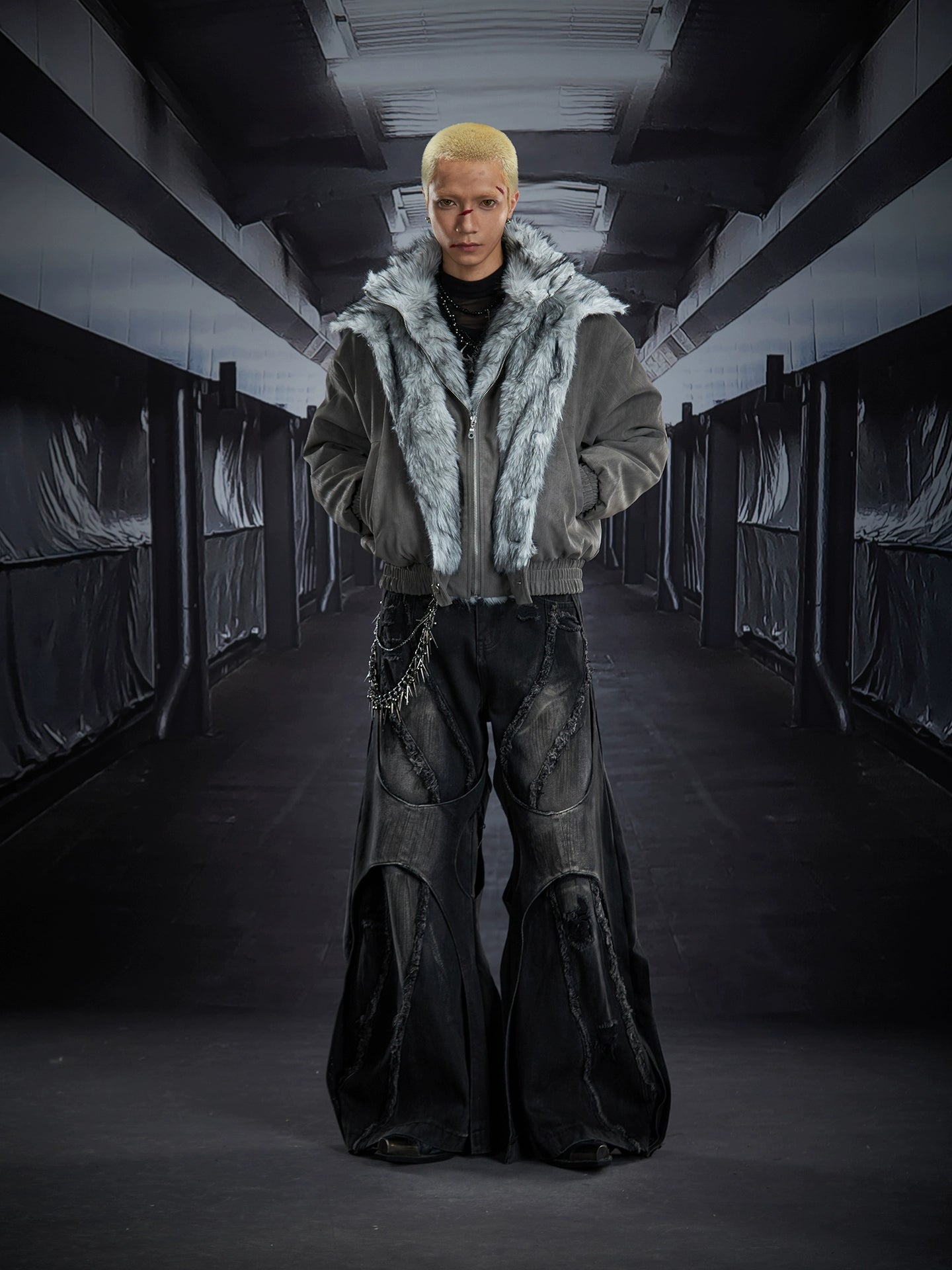 Dual-layer spliced jeans with frayed tassels, washed fading, and wide-leg construction. Sanhoostudio’s dark heavy-duty street aesthetic.