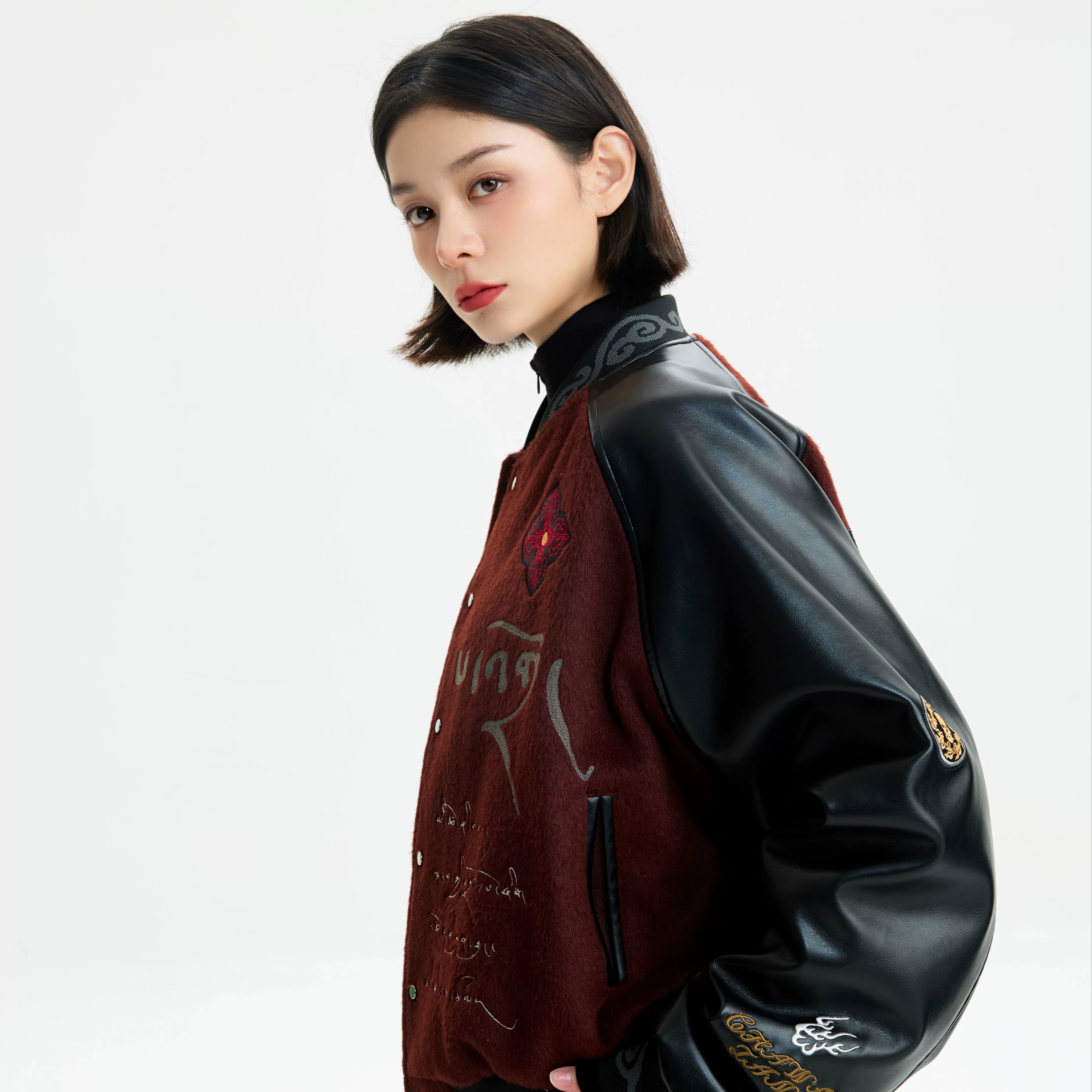 Sanhoostudio padded varsity jacket featuring vintage embroidery and relaxed fit. A unisex winter outerwear essential.