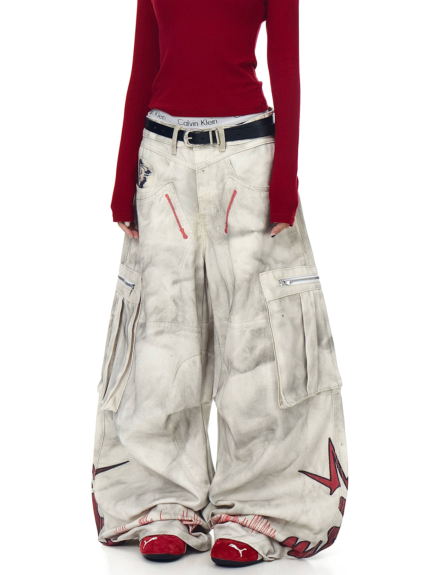 Sanhoostudio wide leg denim pants featuring distressed wash, graffiti details, and multi-pocket workwear design. Built with pleated structure for bold streetwear styling.