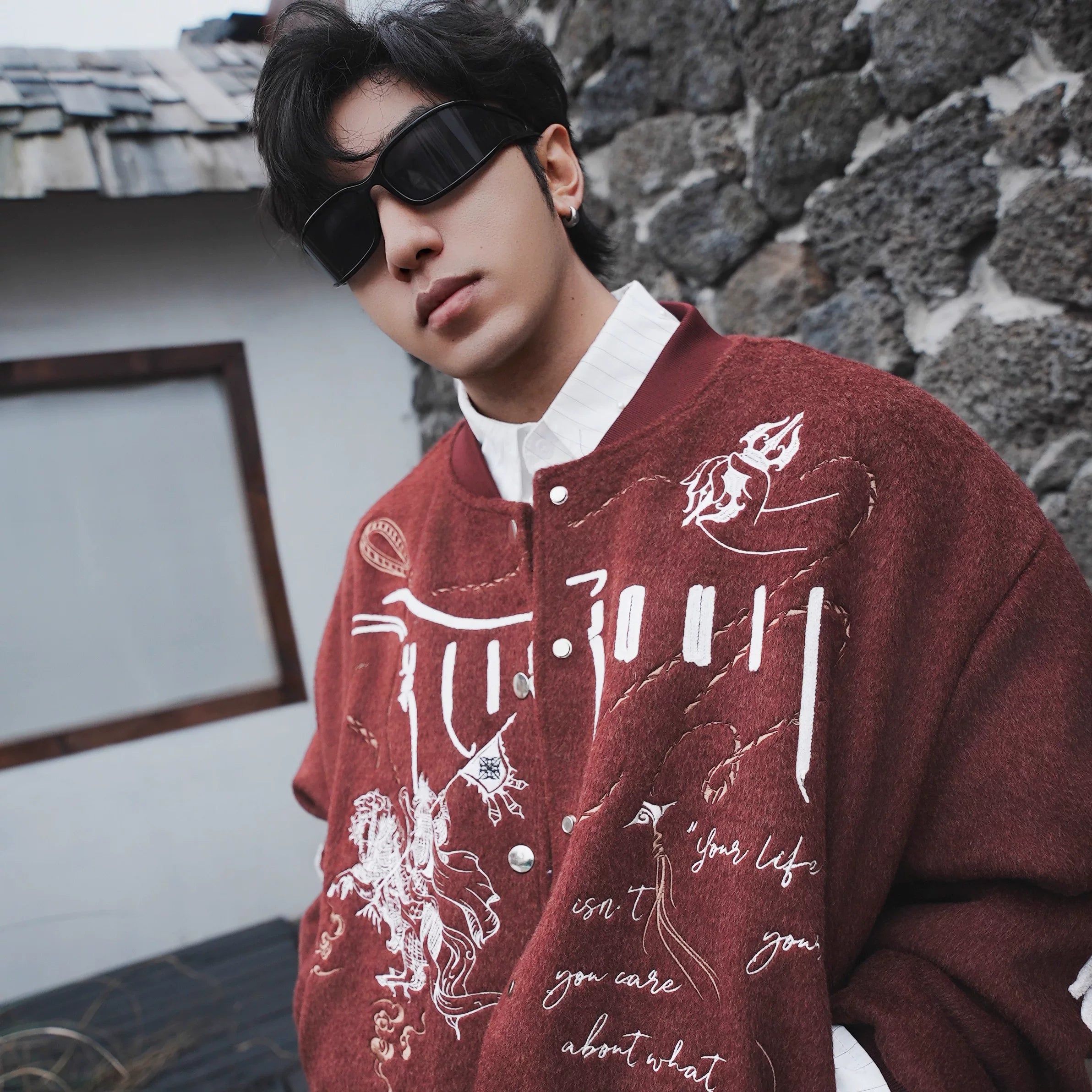 Sanhoostudio heavyweight varsity jacket featuring embroidery and wool blend fabric. Designed for bold unisex streetwear.