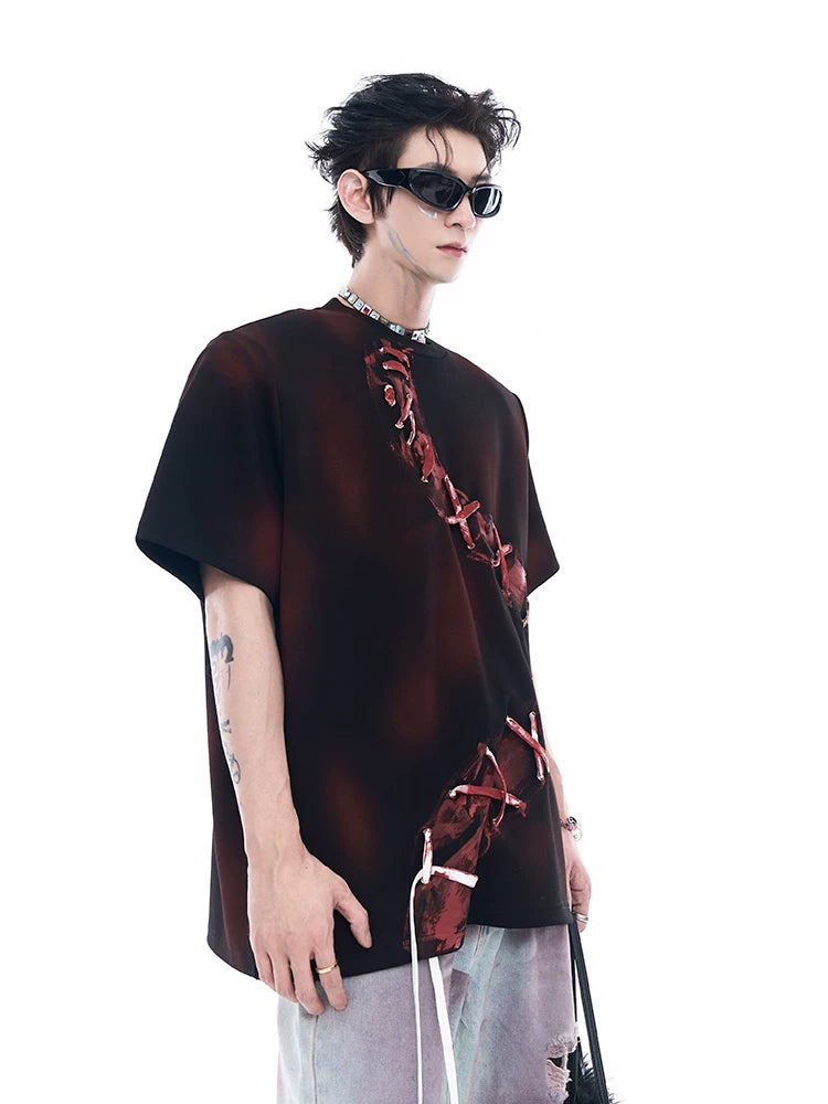Sanhoostudio dark red T-shirt featuring spray dye effect and lace-up design. A unique streetwear piece combining bold color and artistic detailing.