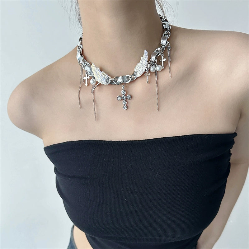 Sanhoostudio’s Y2K-inspired wing cross choker captures futuristic rebellion and feminine strength. A perfect balance between bold design and refined glamour.