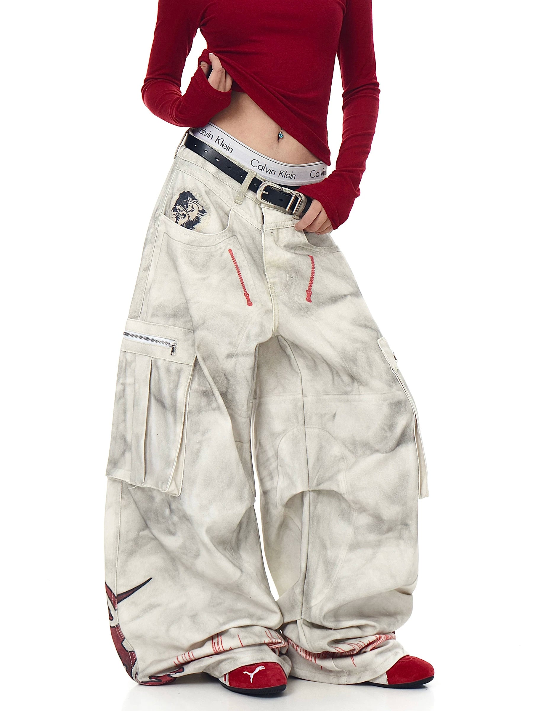 Sanhoostudio wide leg denim pants featuring distressed wash, graffiti details, and multi-pocket workwear design. Built with pleated structure for bold streetwear styling.