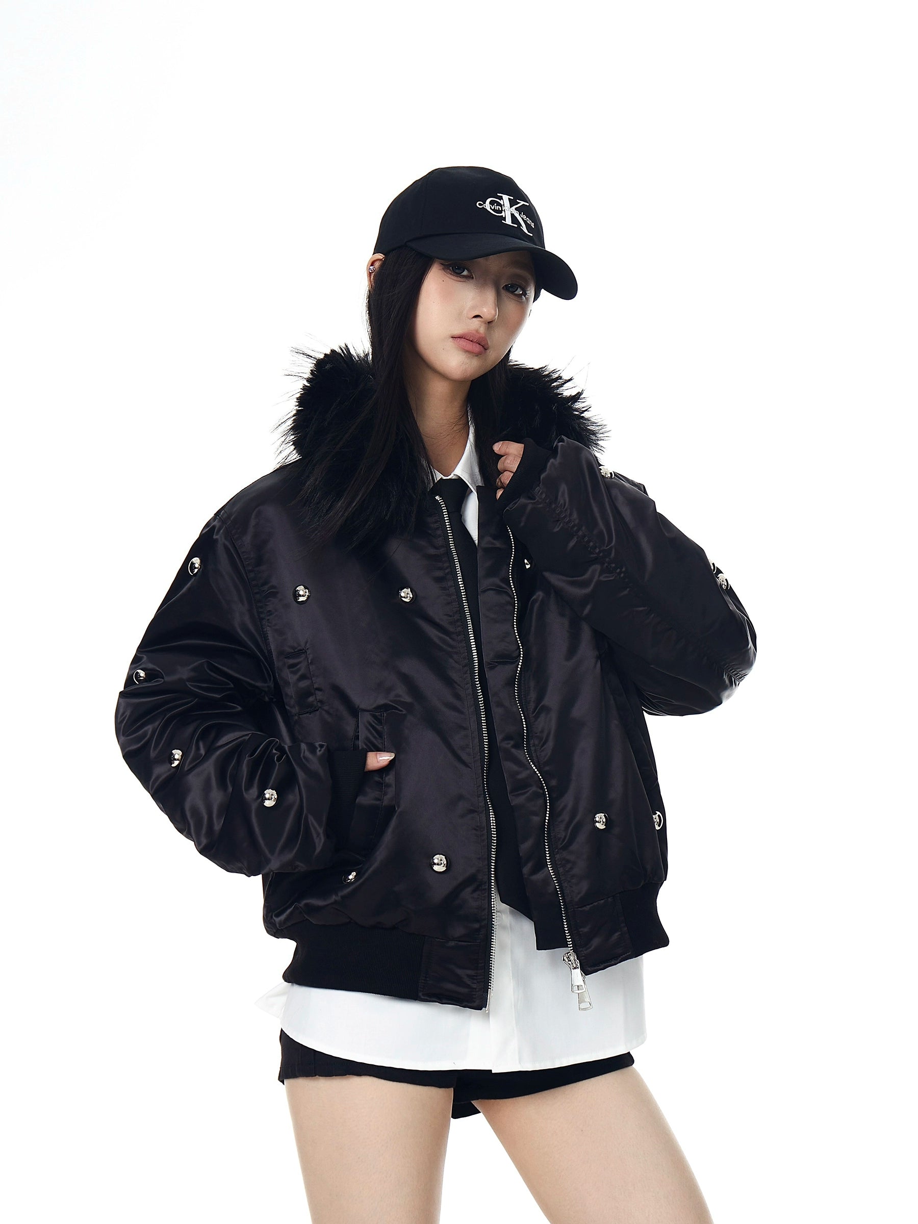 A heavy aviator-style puffer with metal studs, a warm fur collar, and high-street visual impact. Thick, bold, and unisex—perfect for winter street statements. Sanhoostudio exclusive.