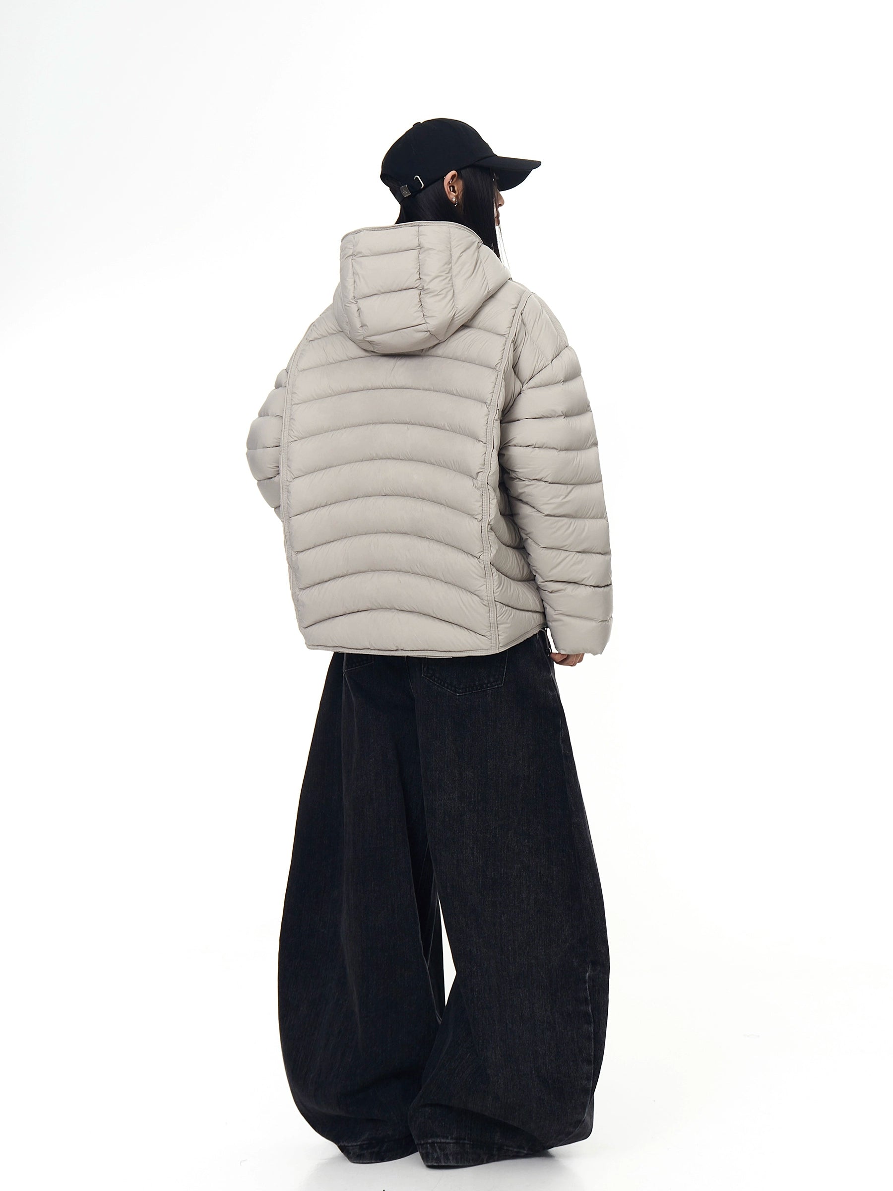 A premium 90% white-duck-down puffer coat featuring ribbed shell stitching and a protective hooded design. Ultra-warm, unisex, and built for winter street style. Only at Sanhoostudio.