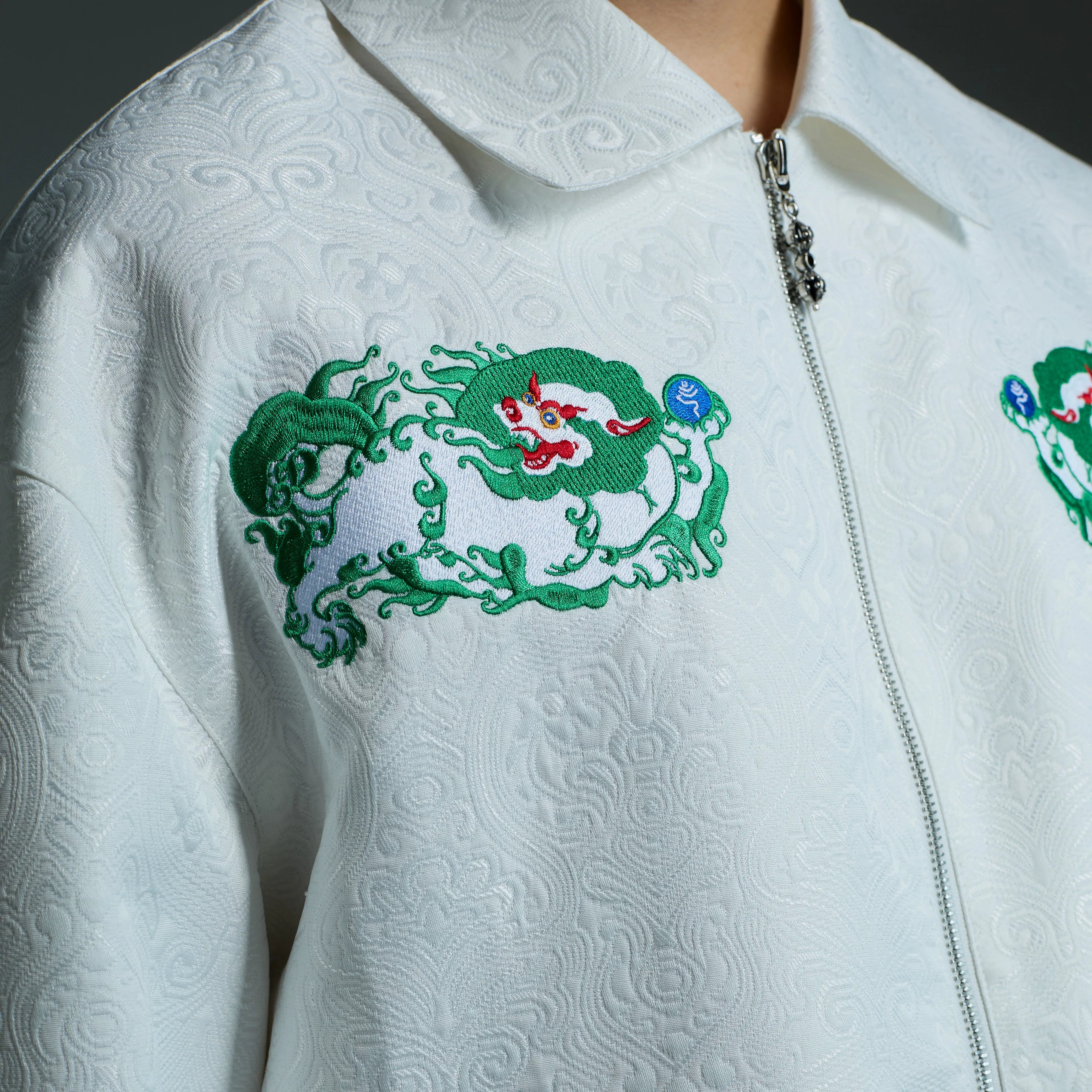 Sanhoostudio embroidered jacket with Tibetan snow lion graphics. A relaxed unisex streetwear piece designed for casual daily wear.