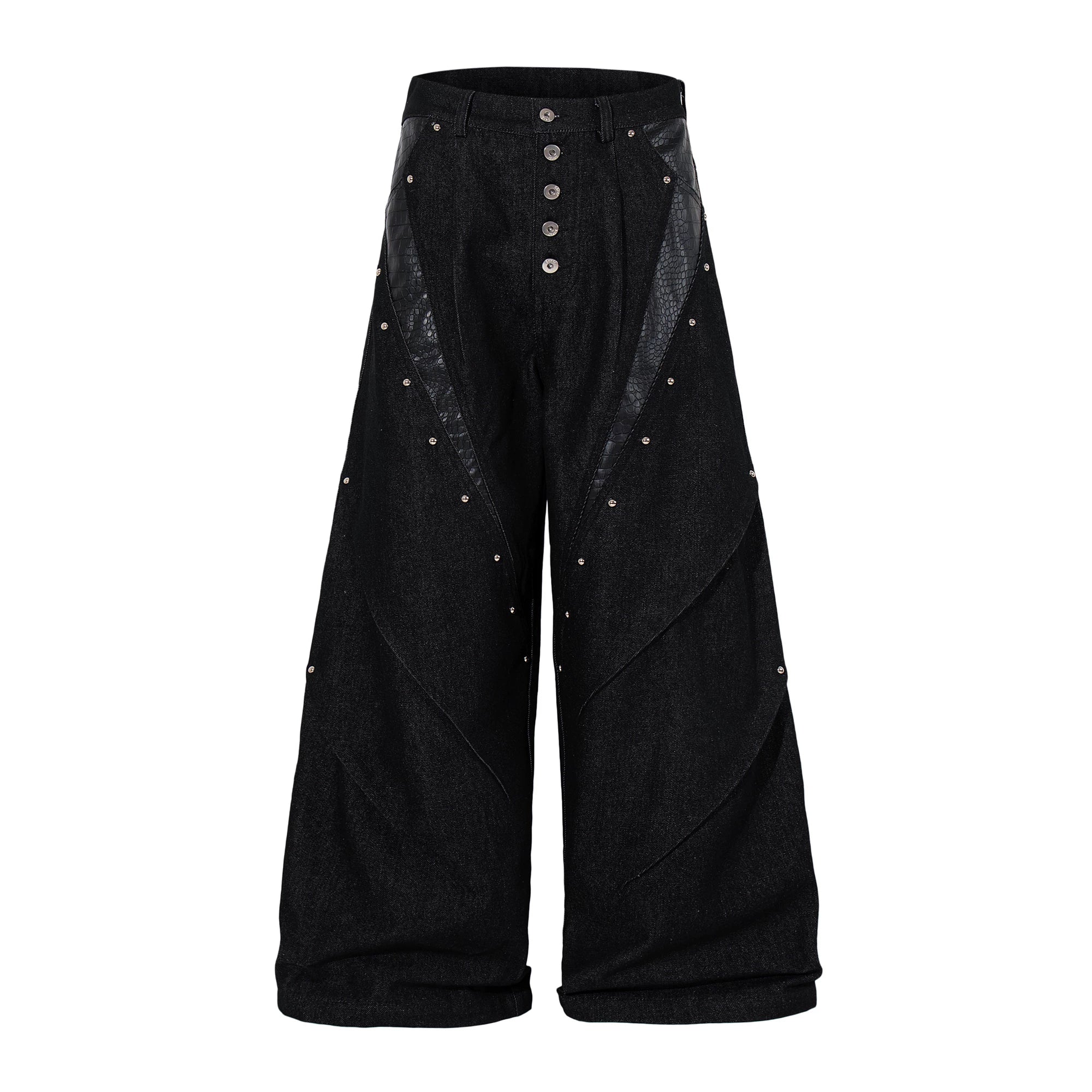 Sanhoostudio denim pants featuring leather patchwork, studded details, and button accents. Designed with a wide leg silhouette for bold streetwear looks.