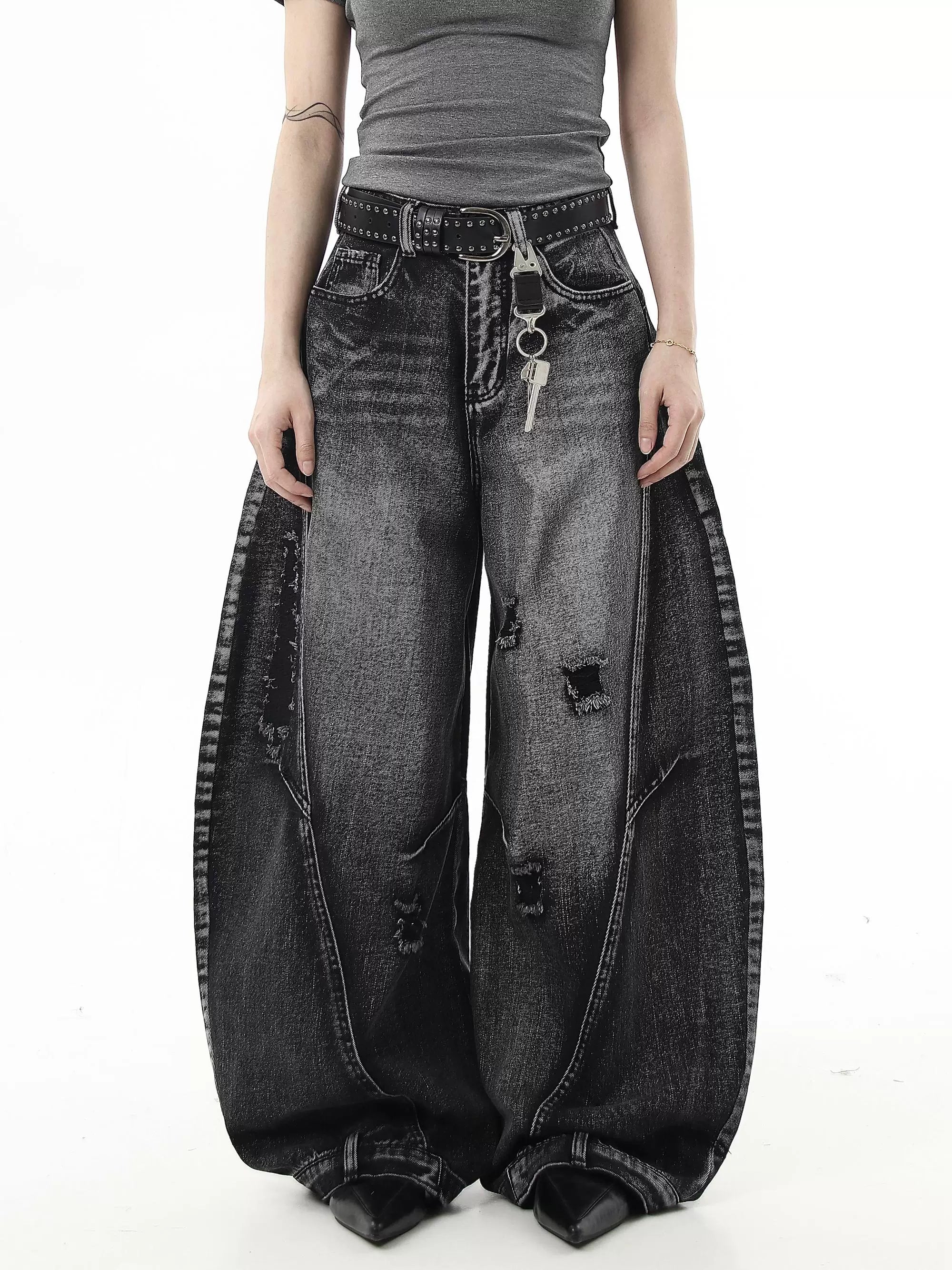 Sanhoostudio wide leg denim pants featuring washed distressing and ripped details. Designed with a curved scythe silhouette for modern high street fashion.