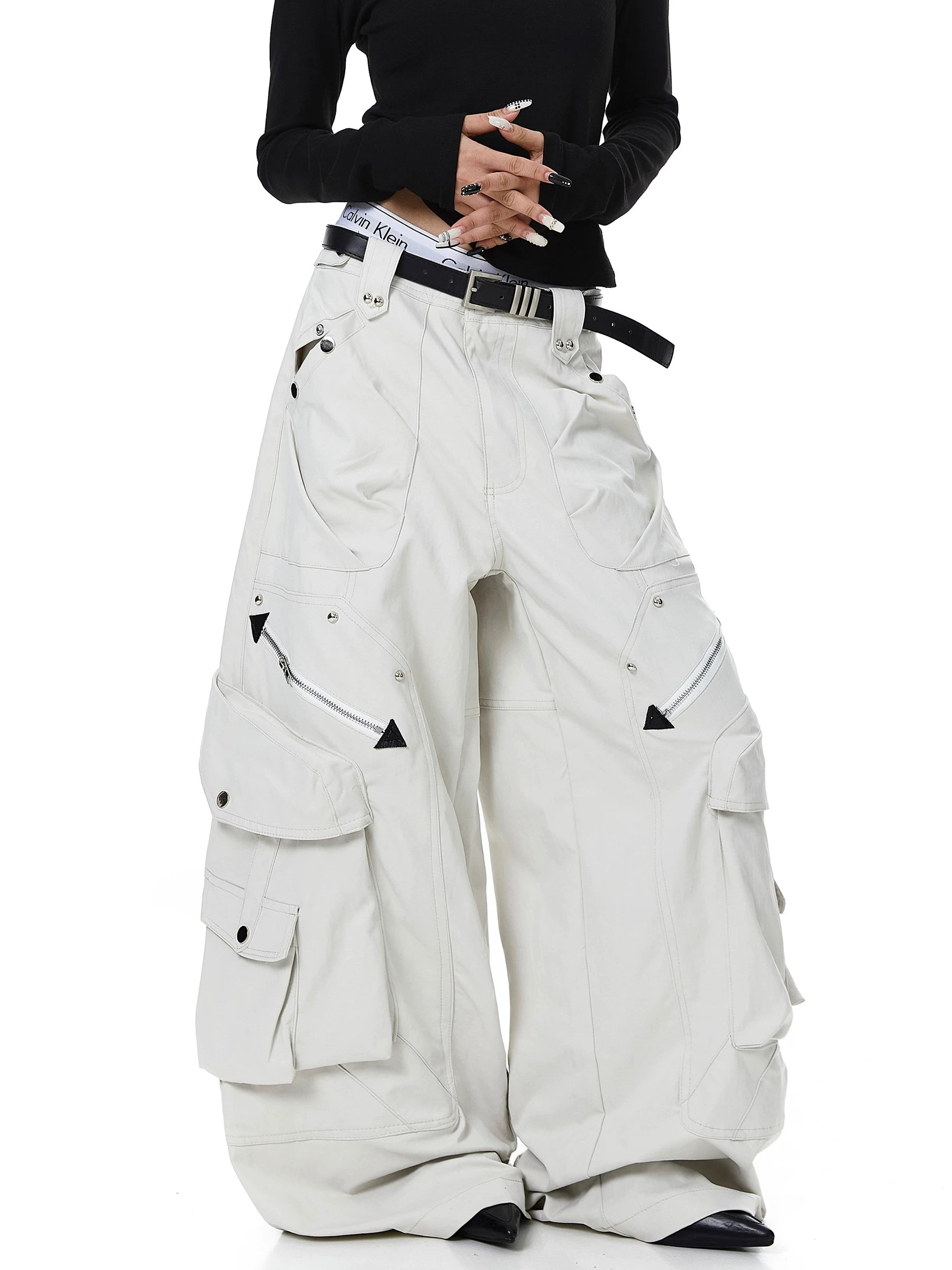 Sanhoostudio cargo pants featuring heavy utility construction, stud details, and multi-pocket design. Built with a wide leg silhouette for bold streetwear outfits.