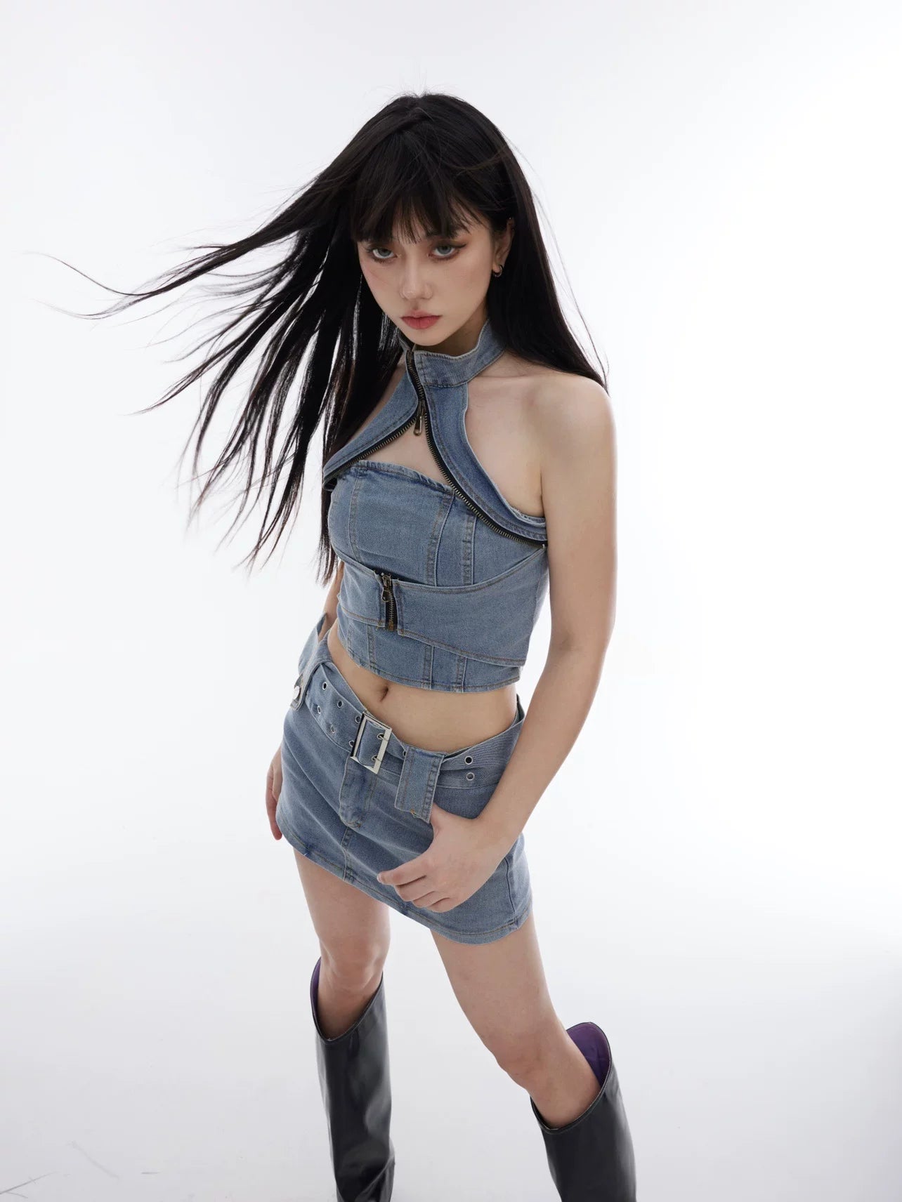 Sanhoostudio denim two-piece set featuring a halter crop top and body-hugging skirt. Designed for a bold and slimming streetwear look.