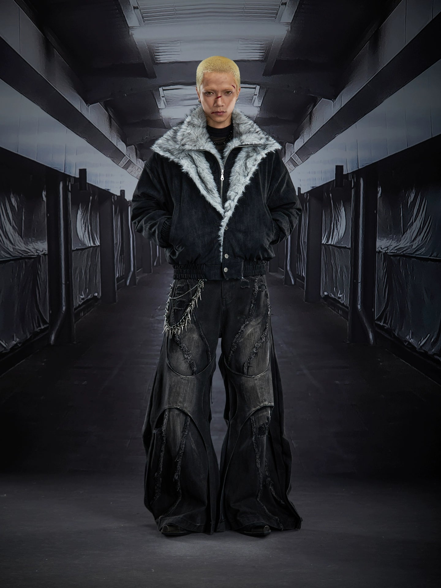 Dual-layer spliced jeans with frayed tassels, washed fading, and wide-leg construction. Sanhoostudio’s dark heavy-duty street aesthetic.