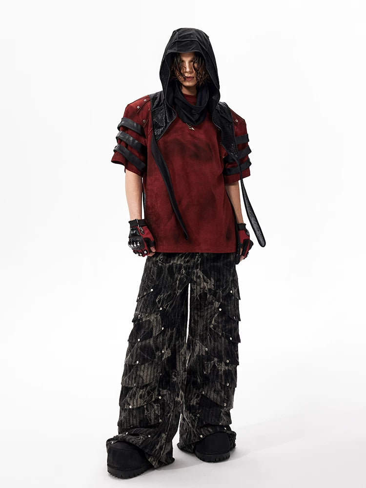 Sanhoostudio dark streetwear T-shirt featuring distressed dye finish, studded details, and leather patchwork accents. Designed with structured shoulder pads and a relaxed fit for bold summer styling.
