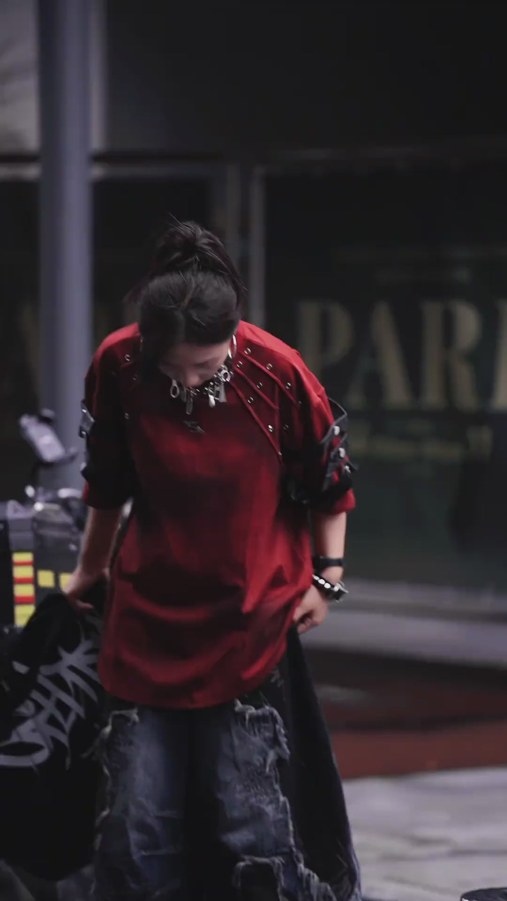 Sanhoostudio dark streetwear T-shirt featuring distressed dye finish, studded details, and leather patchwork accents. Designed with structured shoulder pads and a relaxed fit for bold summer styling.