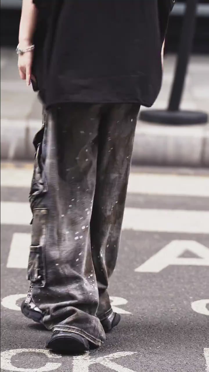 Sanhoostudio wide leg cargo pants featuring distressed wash, paint splatter details, and multi-pocket design. Built for functional streetwear styling with durability, comfort, and bold urban aesthetics.